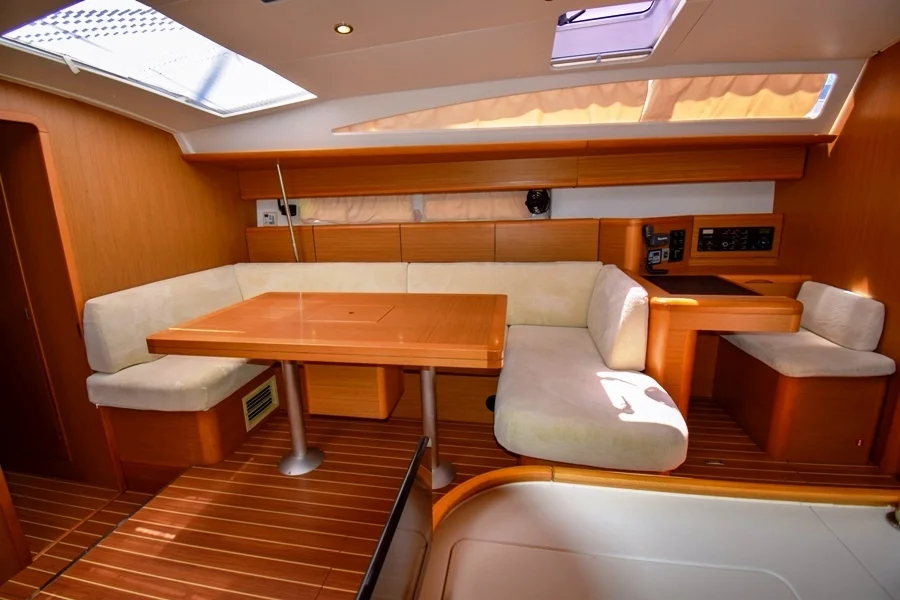 Saloon table in sailing yacht Jeanneau 53 Nazli Denizim for charter in Marmaris in Turkey