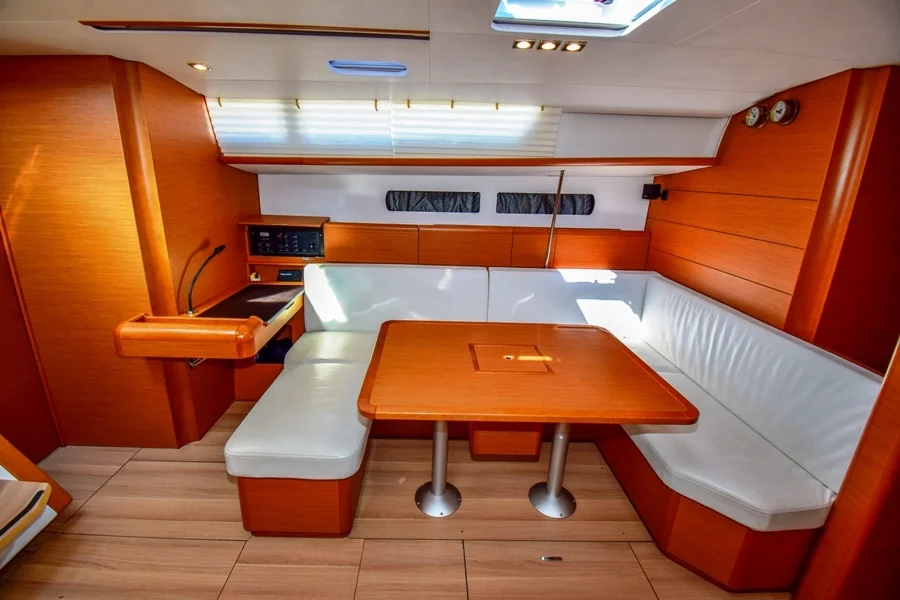 Saloon table in sailing yacht Jeanneau Sun Odyssey 479 Sky Selin for charter in Marmaris in Turkey