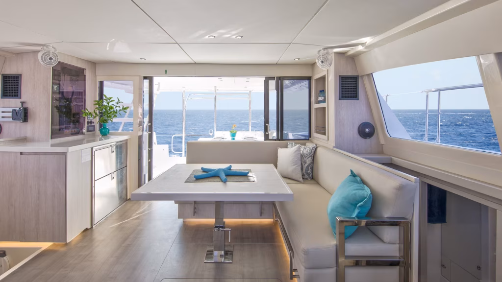 Saloon table in power catamaran Moorings 433 PC for charter in Tortola in British Virgin Islands in Caribbean