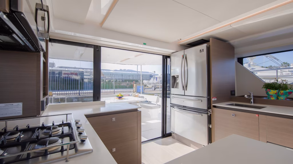 Galley in saloon and cockpit of power catamaran Leopard 53 PC for charter in Tortola in British Virgin Islands in Caribbean